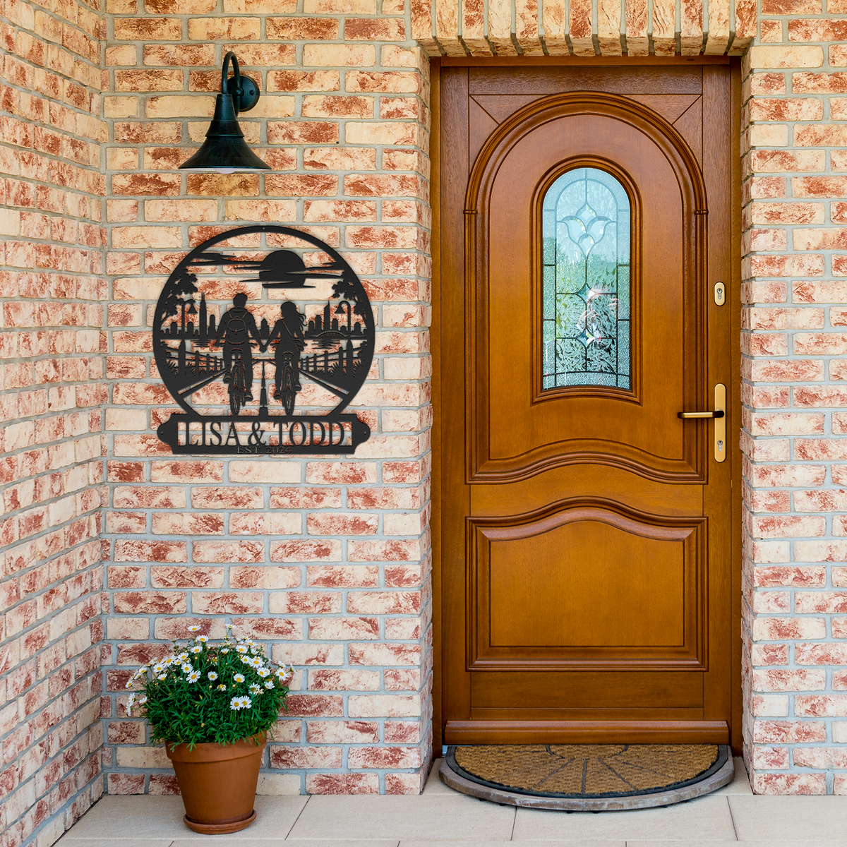 Black custom cycling couple metal sign by brick entrance — personalized couples decor