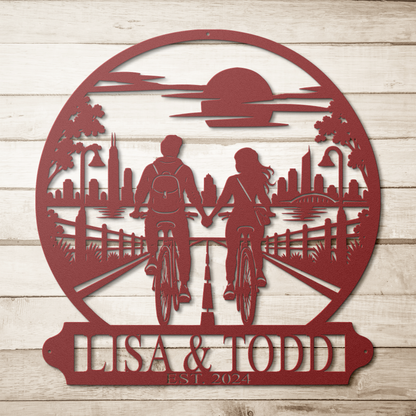 Red custom cycling couple metal sign on a wood background — personalized couples wall art