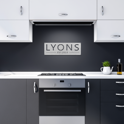 Silver custom family name established metal sign in dark kitchen — personalized family name wall art