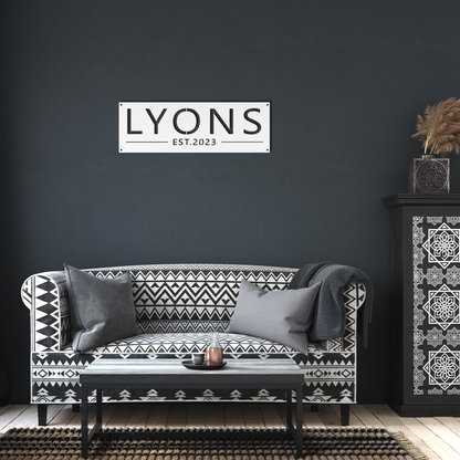 White custom family name established metal sign in living room — personalized family name wall art