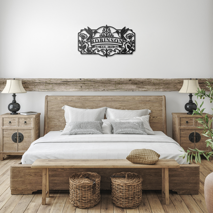 Black hummingbird family name metal sign in farmhouse bedroom — personalized wall art