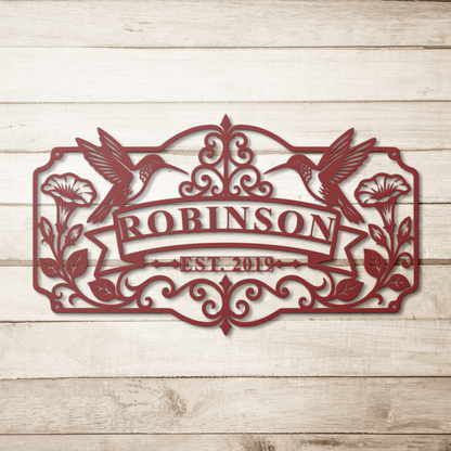 Red hummingbird family name metal sign on wood background — personalized wall art