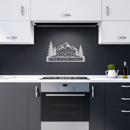 Silver custom mountain pine tree address metal sign in dark kitchen — personalized house number decor