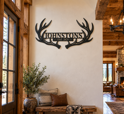 Custom deer antler family name sign in a rustic cabin entryway — personalized established year steel art